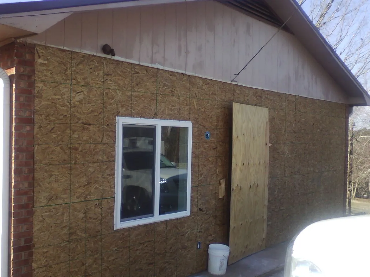 OSB sheathing on a garage addition wall before siding in Stevensville
